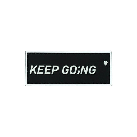 Black and white PVC patch that says Keep Going with velcro hook backing